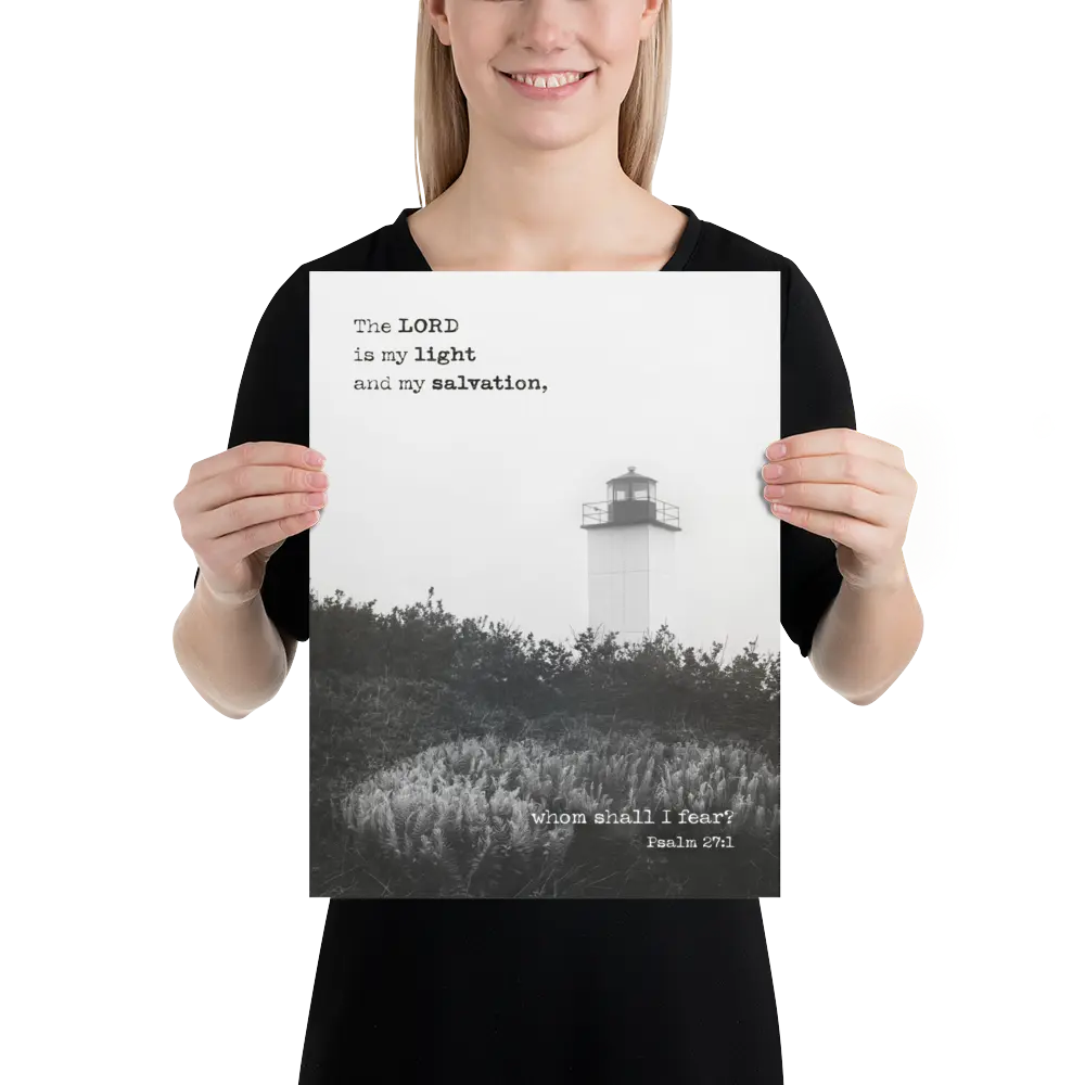 Person holding a poster with a lighthouse and religious text.