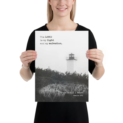 Person holding a poster with a lighthouse and religious text.