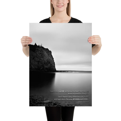 Person holding a large poster with a black and white landscape design.