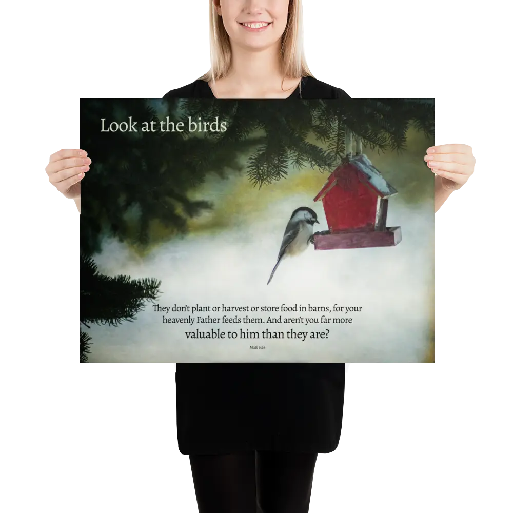 Person holding a poster with a bird and birdhouse illustration and text.