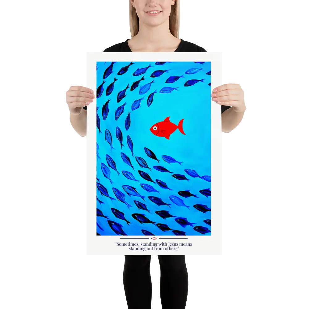 Person holding a poster with a red fish among blue fish on a blue background.