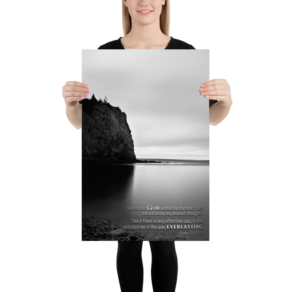 Person holding a poster with a black and white landscape design and text.