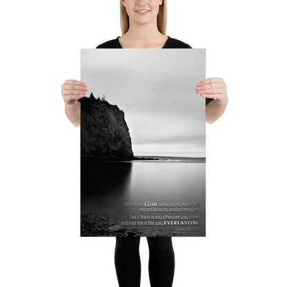 Person holding a poster with a black and white landscape design and text.