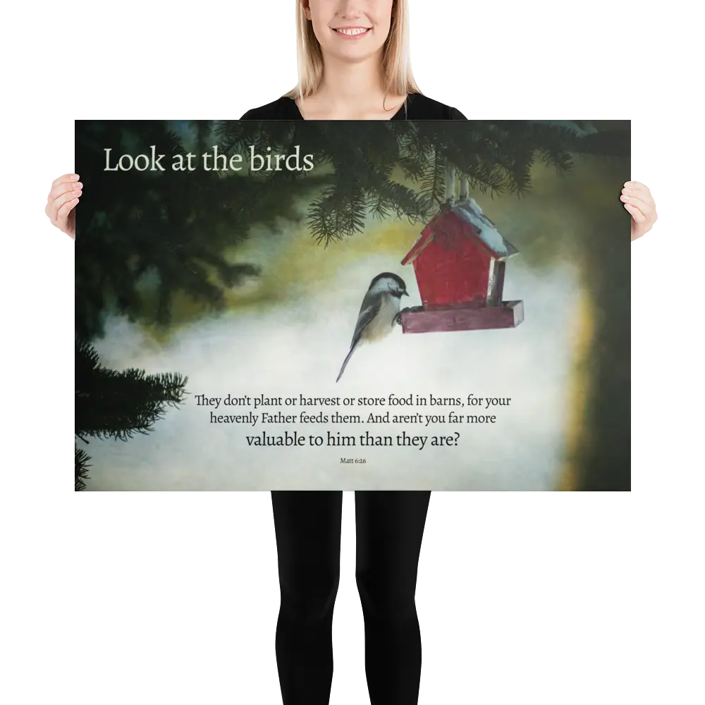 Person holding a large poster with a birdhouse and text.