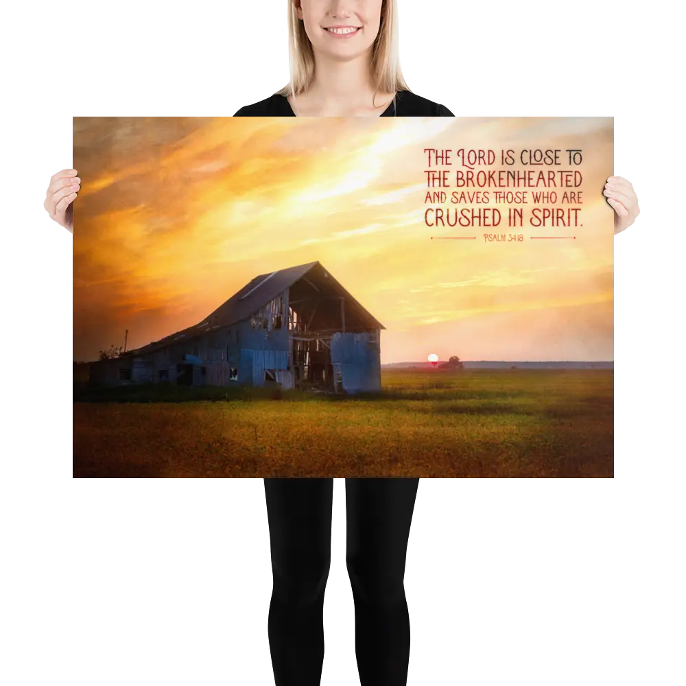 Person holding a large poster with a barn and sunset scene and motivational quote.
