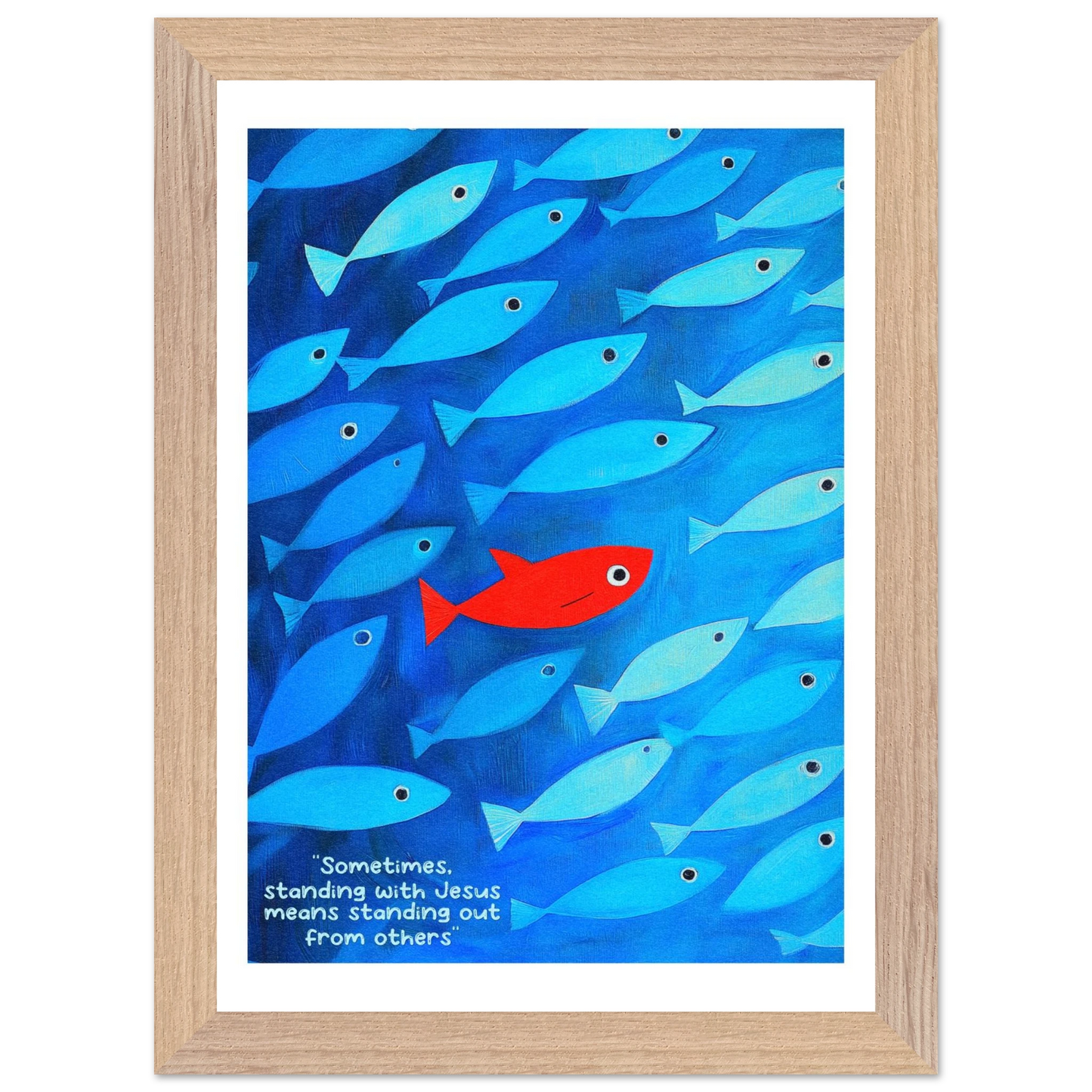 Framed wall art featuring a school of blue fish with a single red fish, and text that reads: 'Sometimes standing with Jesus means standing out from others.'.