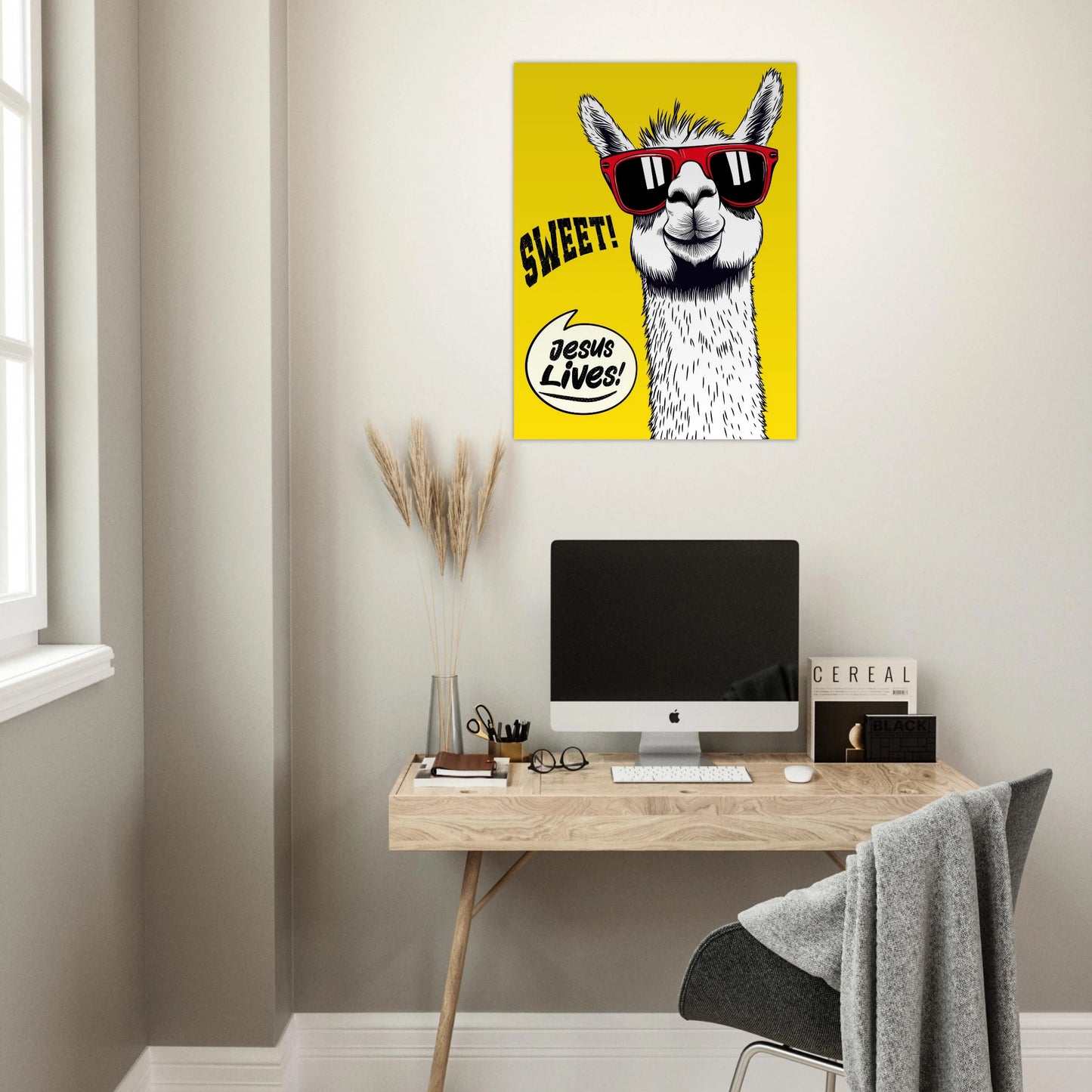 Yellow llama Christian poster hanging above a minimalist home office desk.