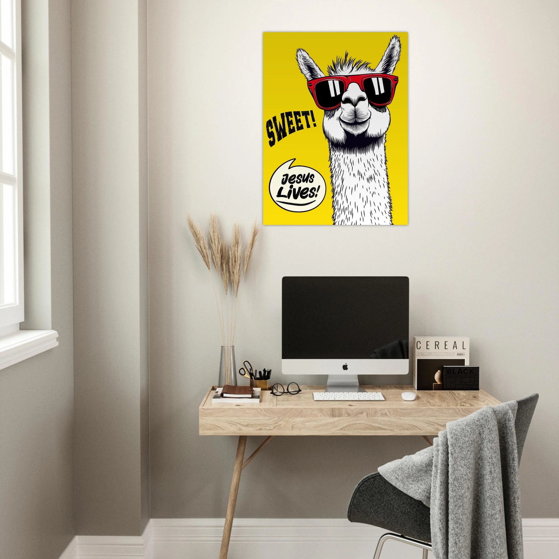 Yellow llama Christian poster hanging above a minimalist home office desk.
