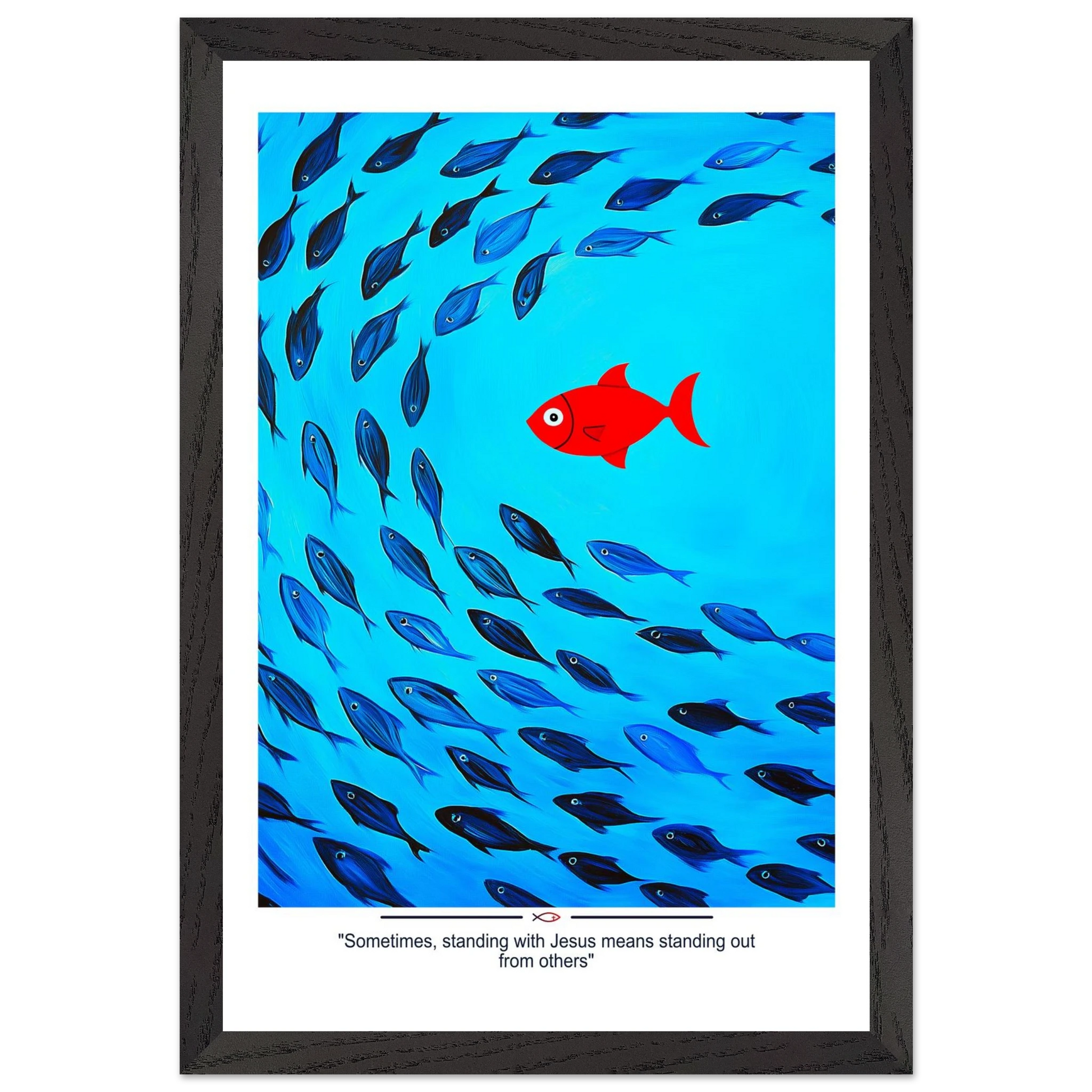 Framed Christian wall art featuring a red fish swimming in water with blue fish, and the text 'Sometimes standing with Jesus means standing out from others' as a quote.