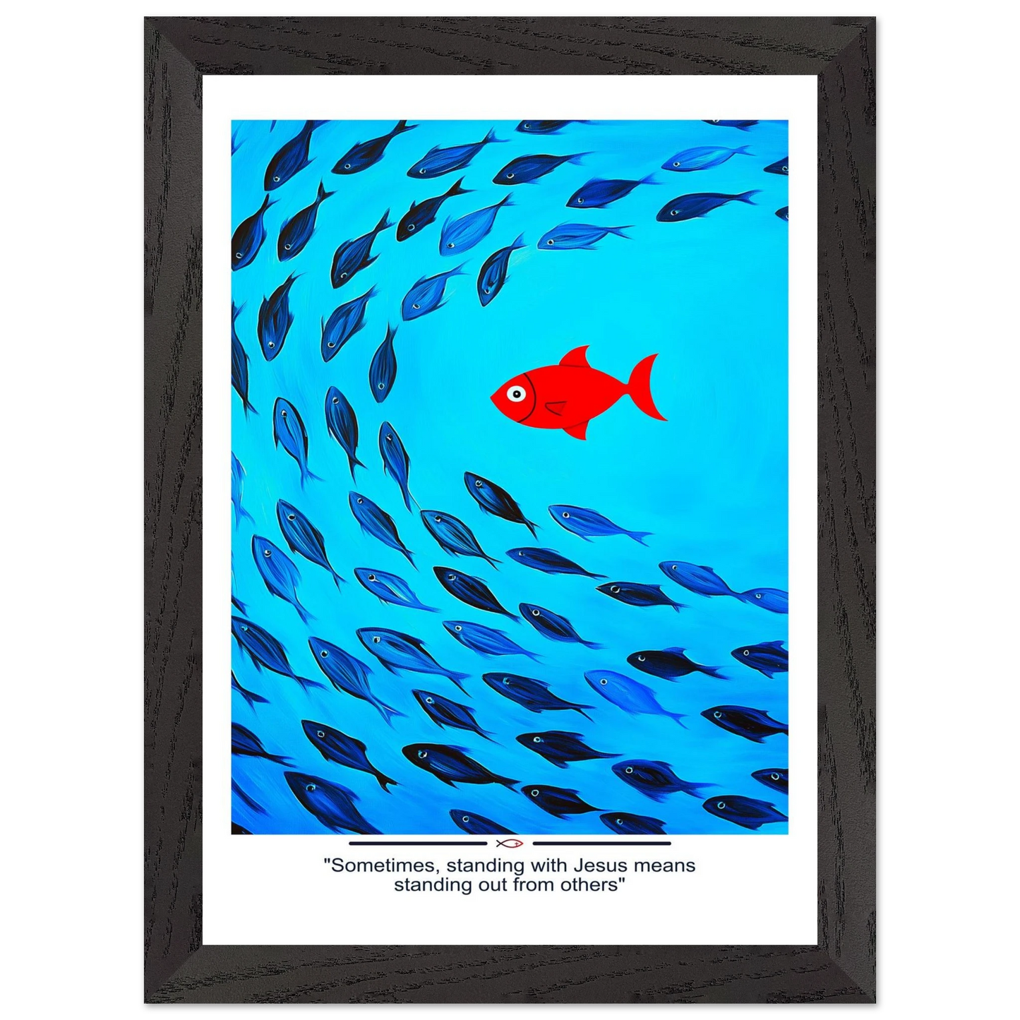 Framed Christian wall art featuring a red fish swimming in water with blue fish, and the text 'Sometimes standing with Jesus means standing out from others' as a quote.