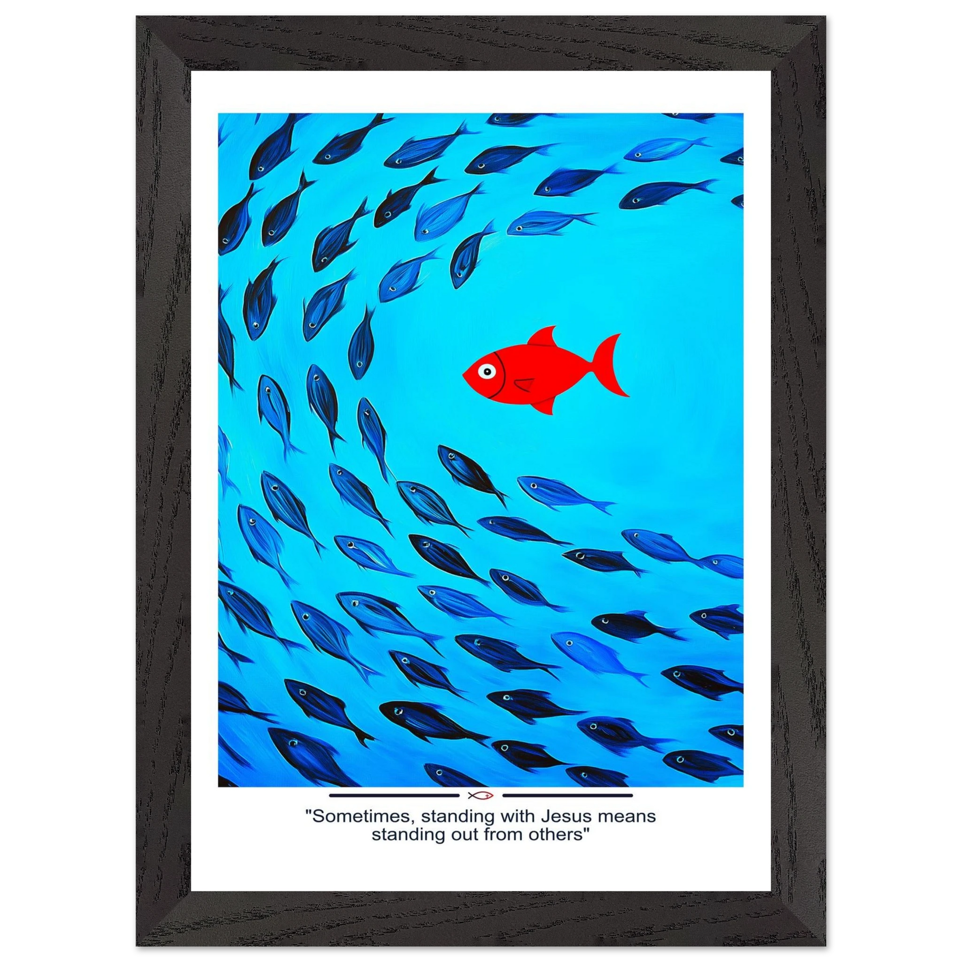 Framed Christian wall art featuring a red fish swimming in water with blue fish, and the text 'Sometimes standing with Jesus means standing out from others' as a quote.